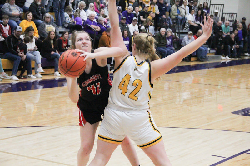 Community R-6 senior Olivia Kuda leans around St. Elizabeth's Sidney Engelmeyer on Tuesday during a Class 1 sectional game in Salisbury. The seniors Kuda, Sarah Angel and Kayla Jett played their final games as Lady Trojans after a 61-41 loss.