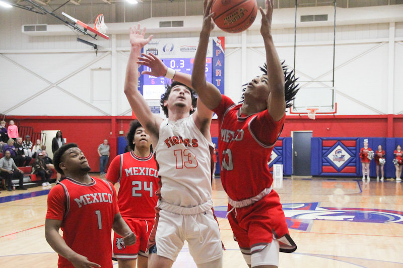 Mexico sophomore PJ Perkins soars for a rebound against Kirksville on Wednesday in the Class 4 District 8 semifinals in Moberly. Perkins put together a good performance on the boards, but the Bulldogs at the line led to a 66-62 loss to end the season.