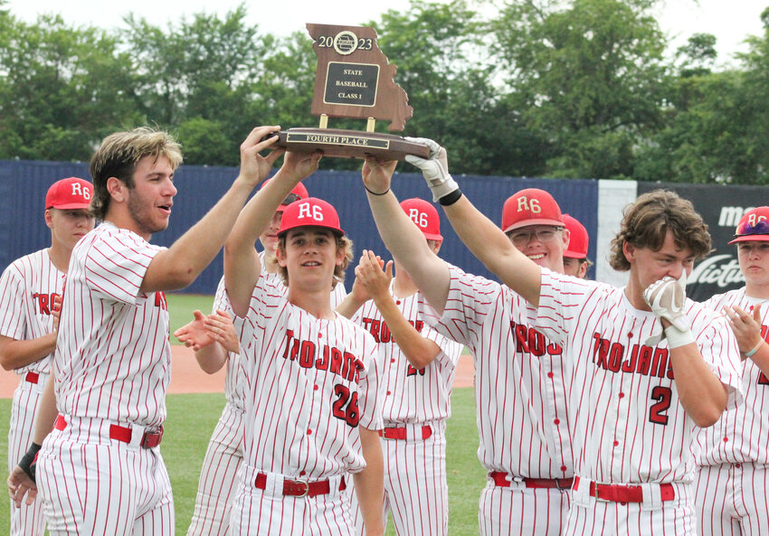 The Trojans' four seniors, from left, Gavin Allen, Tuck er Cox, Pacey Cope and Ayden Meranda, hoist the Class 1 fourth-place trophy after a season they earned their second state Final Four trophy and tied the school single-season wins record.