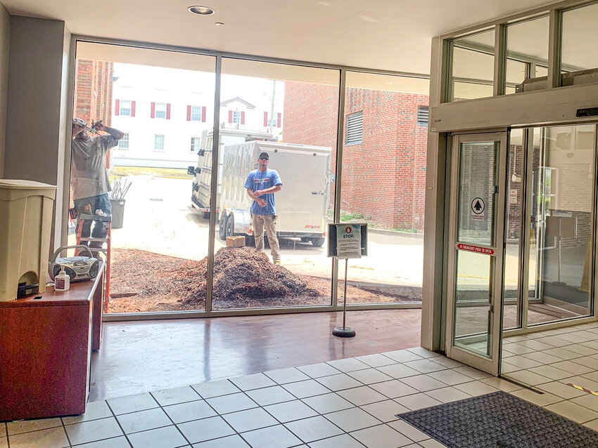 Crews worked on fixing a glass window in the hospital's ER unit last summer.
