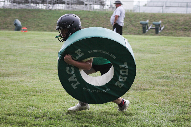 North Callaway senior Kyle Pennell shoulders through equipment during a practice. Pennell will be one of the senior leaders at linebacker this season.