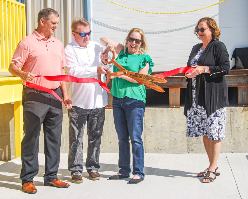 Mexico Chamber of Commerce President Todd Geeson, left, and Mexico Economic Development Director Amy O&rsquo;Brien, right, helped Tom and Brenda Cagney cut the ribbon on the new expansion at Abacus Logistics Solutions on Tuesday, Aug. 29.