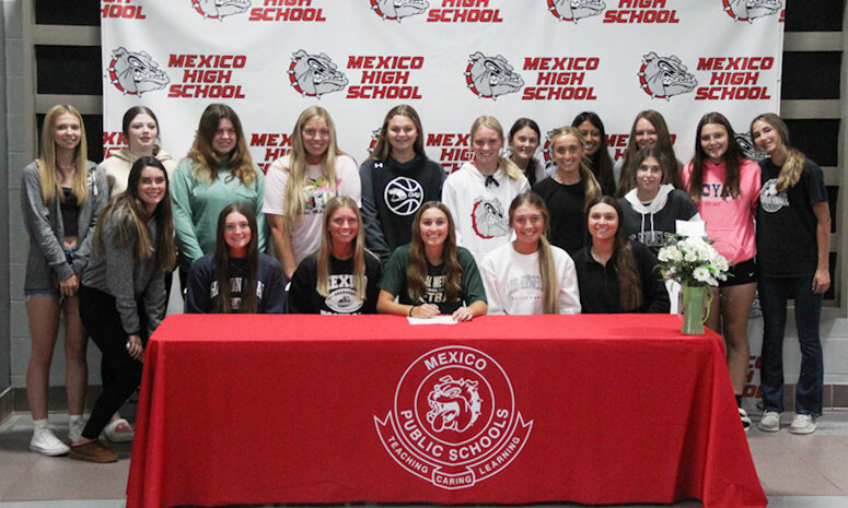 Mexico senior Brooke Teel is surrounded by her teammates on Wednesday at the Mexico Sports Complex during her college signing ceremony. The quick leadoff hitter will play softball for Central Methodist University in Fayette.