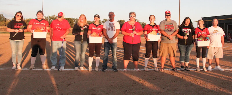 The four Community R-6 seniors, from left, Paige Painter, Taylor Johnson, Brooklynn Glasgow and Alyssa Beamer are with their families on Thursday during a Senior Night ceremony in Laddonia. The Lady Trojans had just defeated Marion County 16-1.