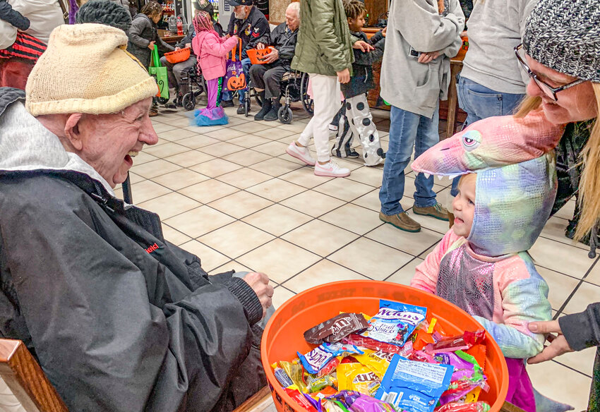 One of the many Veterans at the Missouri Veterans&rsquo; Home enjoyed a moment with one of the hundreds of children who showed up at the home on Halloween.