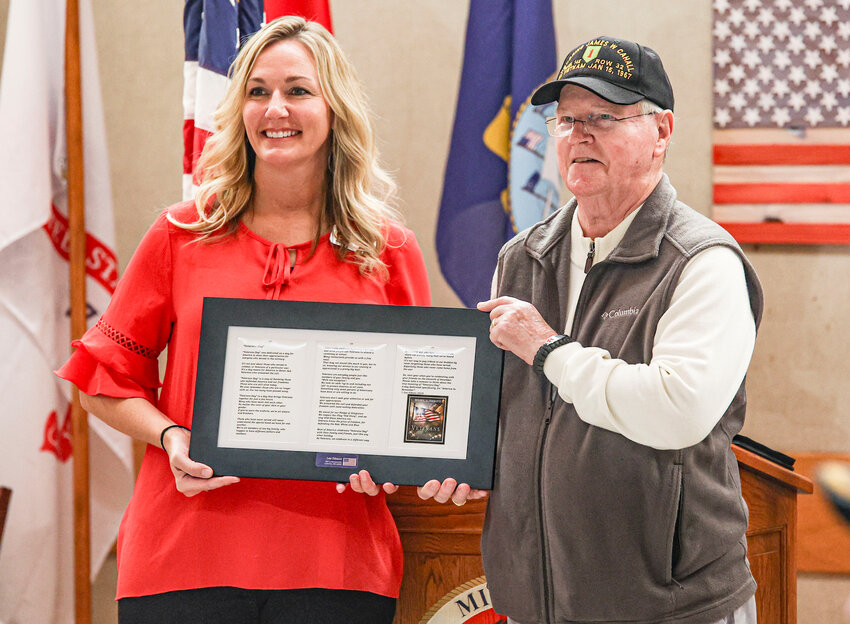 Veteran Les Gipson, right, presents Missouri Veterans&rsquo; Home director Aliesha Edwards with a framed copy of his Veterans&rsquo; Day poem.
