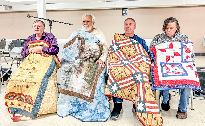 Veterans of Valor proudly display their Quilts of Valor from left, Larry Lochridge, Herman Paul Thompson, Robert Yeager, and Jolene Matich.