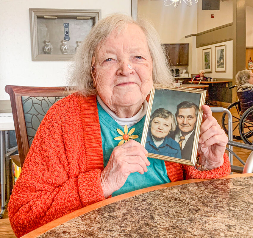 Alma Turpin-Woodward holds an old photo of her and her late husband Homer just a few days before her 100th birthday. The couple were married for more than 54 years until he died in 1996.