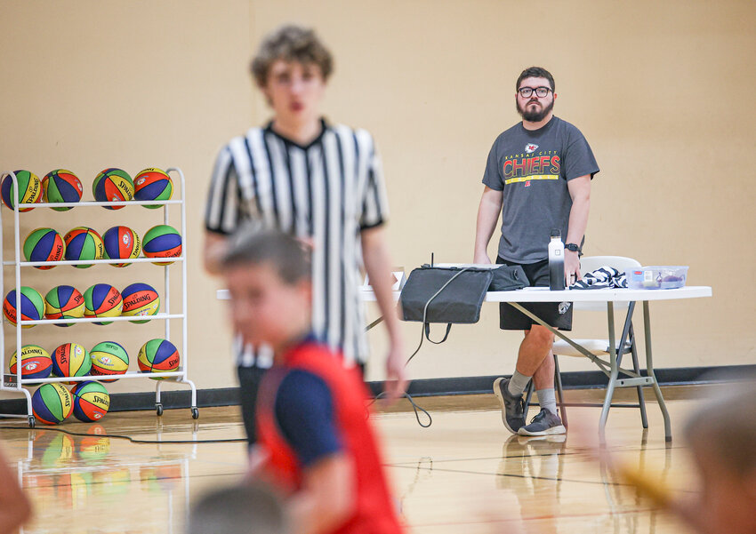 Mexico YMCA Recreation Director Seth Cooke watches the score table at a youth basketball tournament on Saturday, Dec. 9.