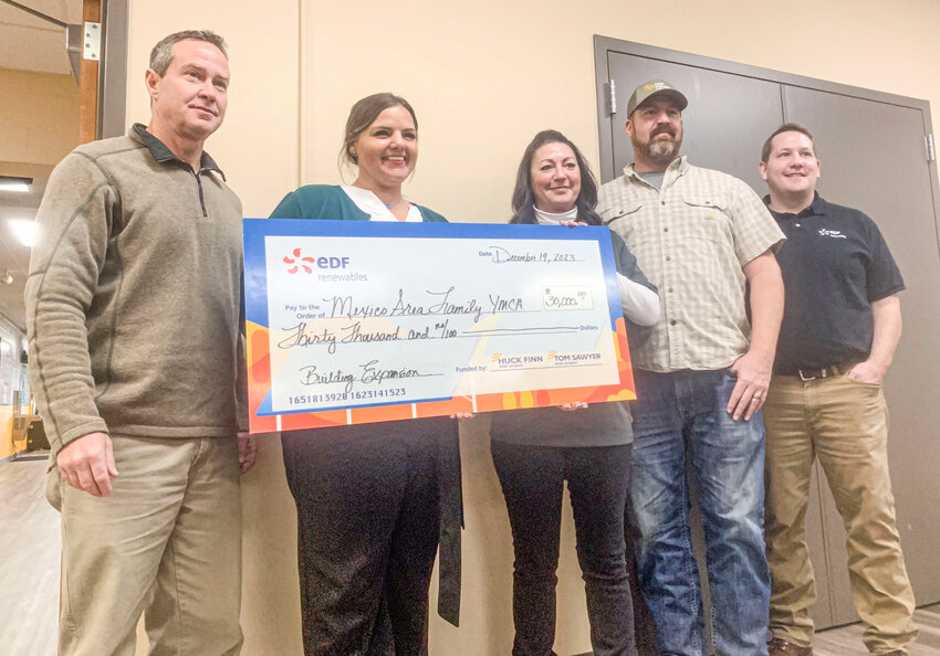 From left, YMCA Board President Lynn Thompson and YMCA Director Brooke Oliver accepted a $30,000 donation from EDF Energy&rsquo;s Stephanie Miller, David Licking, and Cody Dierks at the YMCA board meeting on Dec. 19.