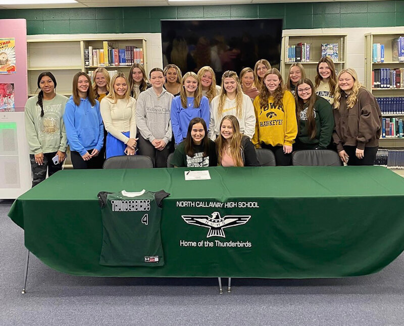 North Callaway senior Corynne Miller is surrounded by her softball teammates on Jan. 4 at North Callaway High School for her college signing ceremony. Miller will play softball for William Woods University.