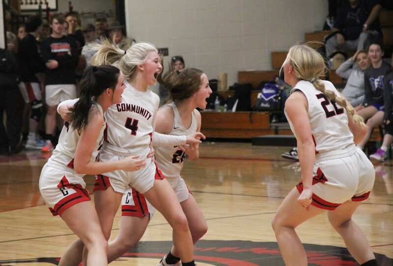 Community R-6 sophomore Peyton Beamer (4) celebrates with her teammates after she hit a game-tying 3-pointer to send Thursday's home game into overtime. The Lady Trojans won the double-overtime game for their first victory in extra time this season.