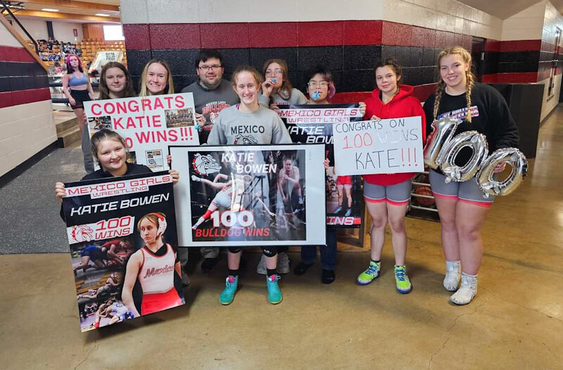 Mexico senior Katie Bowen gathers with her head coach Tony Senor and teammates on Friday at a tournament in Buffalo to celebrate her 100th career win. Fellow senior Karisa Hayden celebrated her 50th career win not too long ago.