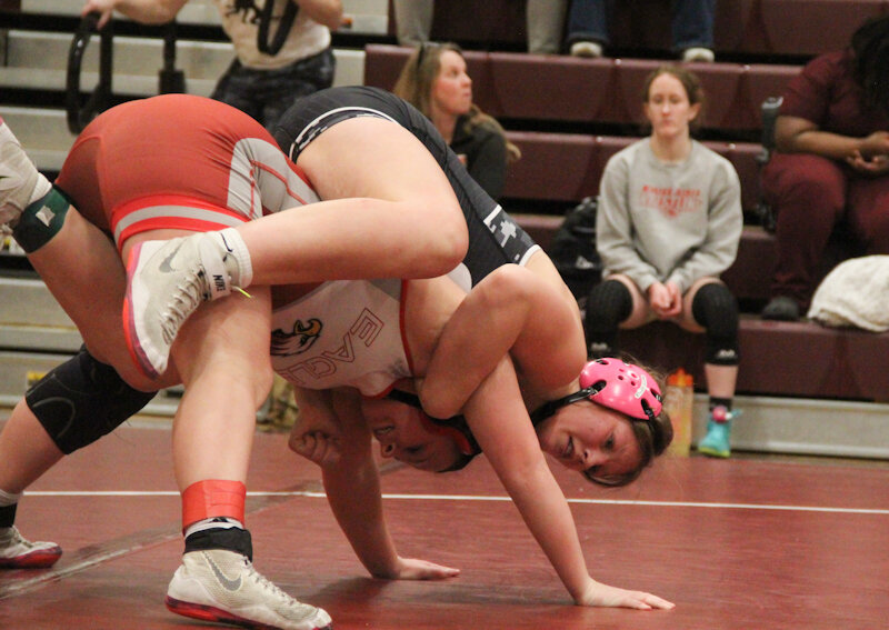 Centralia freshman Jayci Shelton wraps around her opponent during Saturday's district meet at St. Charles West. Shelton is going to her first state meet as the first district champion in Centralia girls wrestling history.