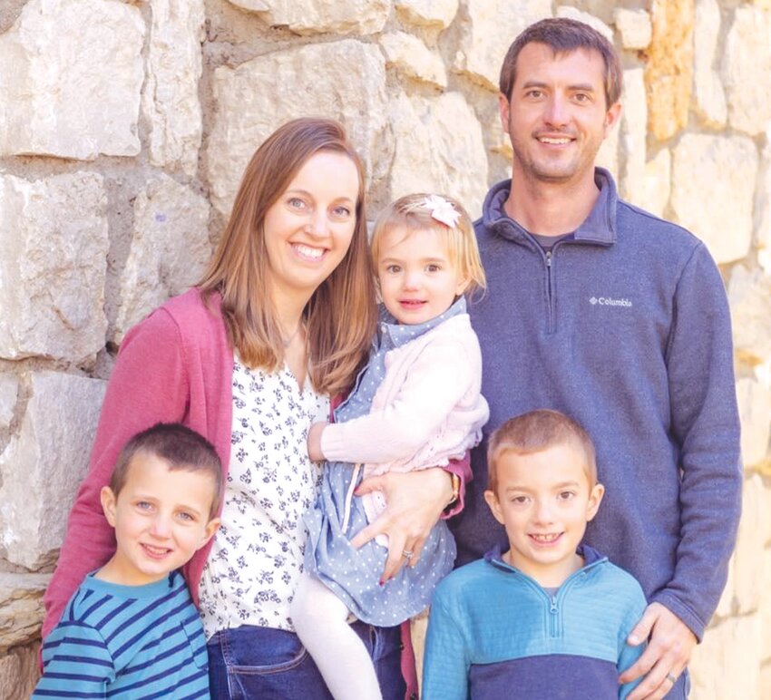 Amy Newland with her husband Wesley are joined by their children Grayson, Reid and Kennedy.