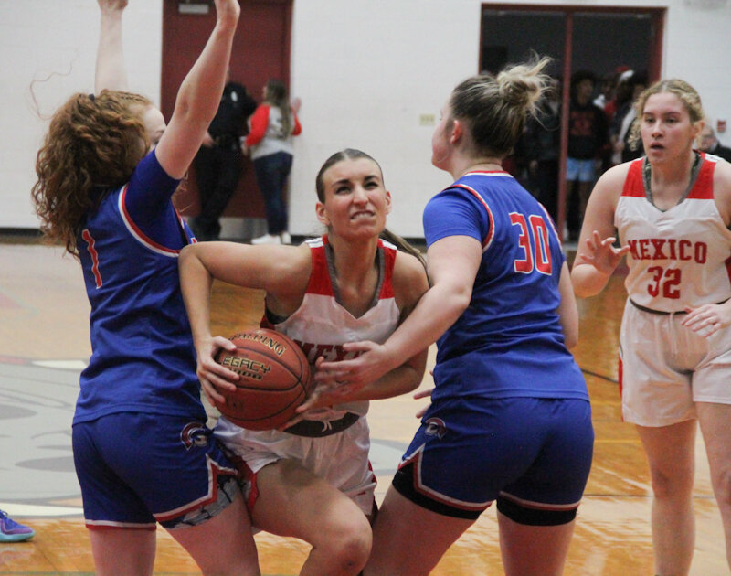 Mexico junior Claire Hudson fights through contact from the Moberly defense on Monday in Mexico.