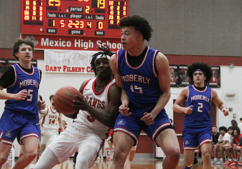Mexico senior DJ Long runs into a Moberly defender on Monday, which was the same night the Bulldogs won on Senior Night and when Long scored his 1,500th career point.
