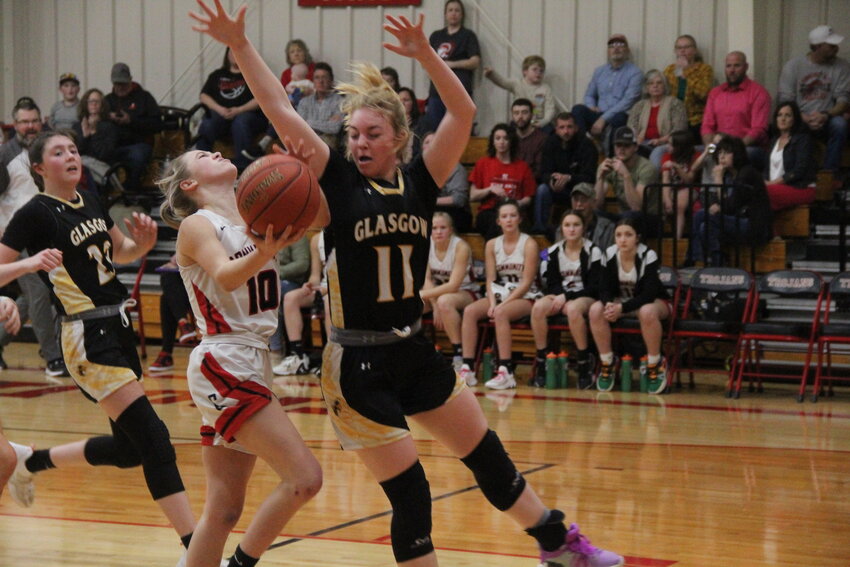 Community R-6 senior Alyssa Beamer goes for a contested layup in transition in an earlier game this season against Glasgow. Beamer led with fellow senior Brooklynn Glasgow with 15 points in the Lady Trojans' final game this season in Wednesday's district semifinals at Blair Oaks in Wardsville.