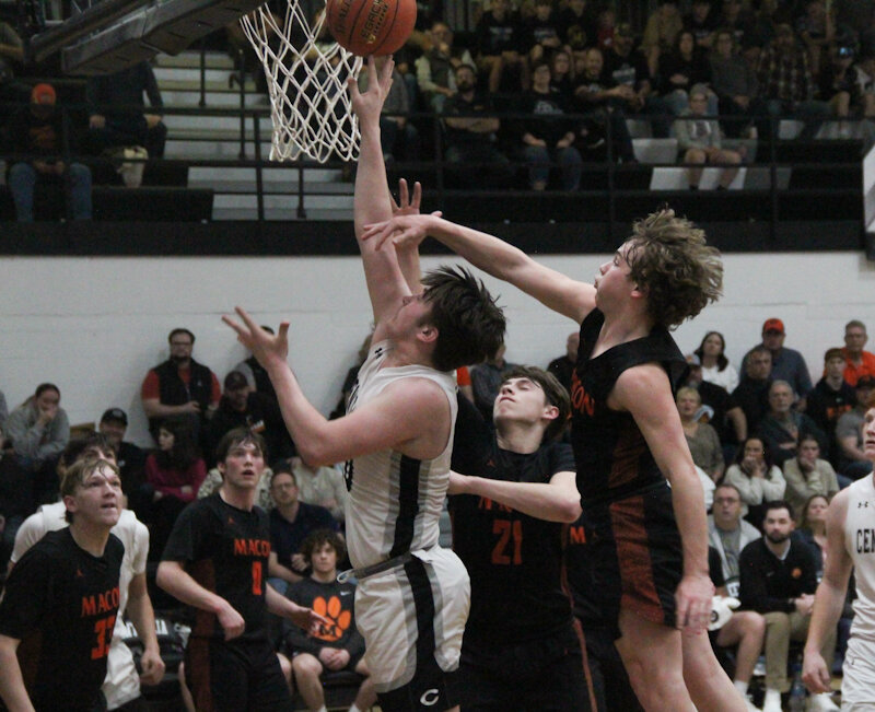 Centralia sophomore Anthony Ford puts in an offensive rebound against Macon on Tuesday in the first round of the Class 4 District 8 tournament in Centralia. Ford finished with a double-double of 17 points and 10 rebounds to lead the Panthers to an opening-round win.