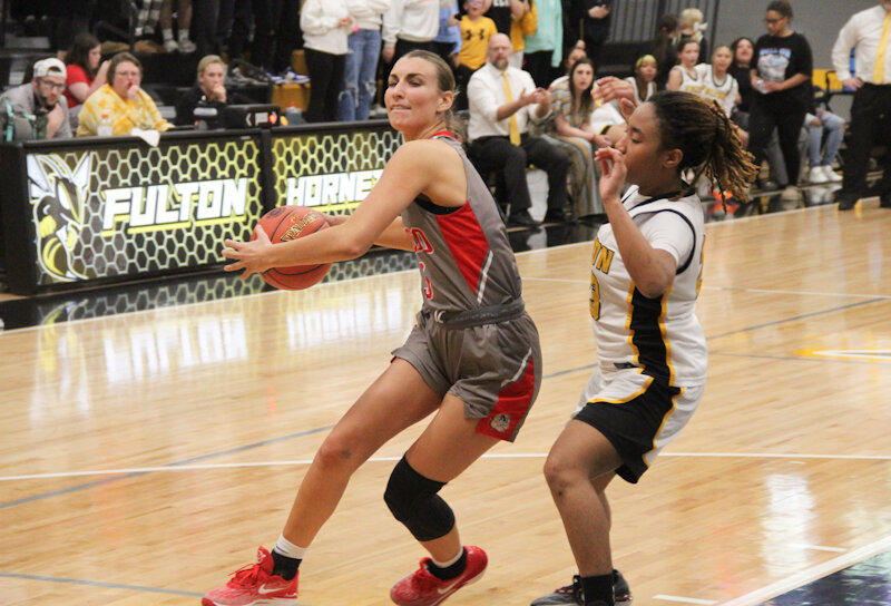 Mexico junior Claire Hudson maneuvers around Fulton's Kier Henderson on Wednesday in the Class 4 District 8 semifinals in Fulton. Hudson scored 15 of her 18 points in the third quarter.
