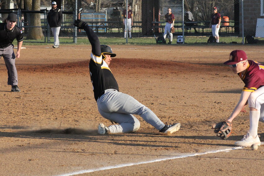 Van-Far junior Tyson Douglas slides into third base against Missouri Military Academy on Tuesday at home in Farber.