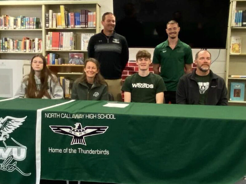 North Callaway senior Isiah Craighead sits with his family during his signing ceremony on Thursday at the high school to compete in track and field for William Woods University in Fulton. Craighead broke his own javelin school record in the Eastern Missouri Conference meet.