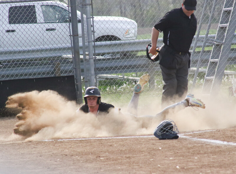 Van-Far junior Carson Huff slides into home plate, kicking up dirt and scoring the Indians' only run in an 8-1 loss to Wright City on Monday in Farber.