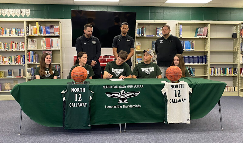 North Callaway senior Sam Pezold signs his letter of intent last Wednesday at North Callaway High School in Kingdom City to play college basketball for William Woods University in Fulton.