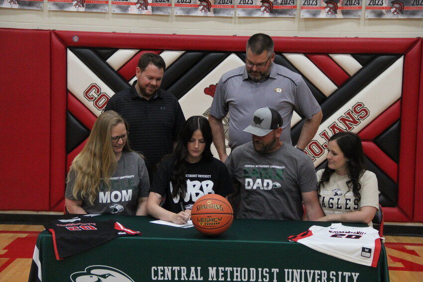 Community R-6 senior Kylie Brooks signs her letter of intent last Wednesday at Community R-6 High School in Laddonia to play college basketball for Central Methodist University in Fayette.