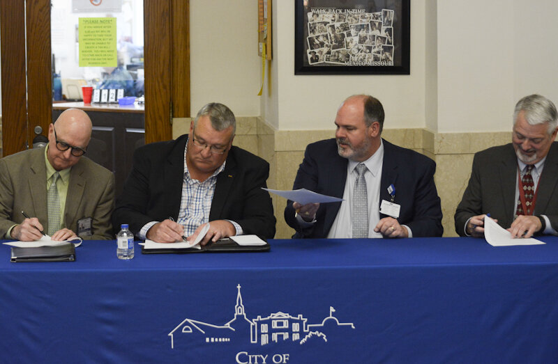 Signing the NDA between Boone Health and Audrain County during a ceremony Friday at the Audrain County Courthouse rotunda, from left, are Audrain County Health Department CEO/administrator Craig Brace, Mexico City Manager Bruce Slagle, Boone Health CEO Brady Dubois and Audrain County Presiding Commissioner Alan Winders.