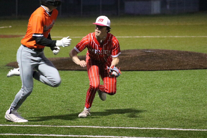 Mexico sophomore pitcher Drew DeMint charges at a Kirksville runner to make a tag on Thursday in Mexico.