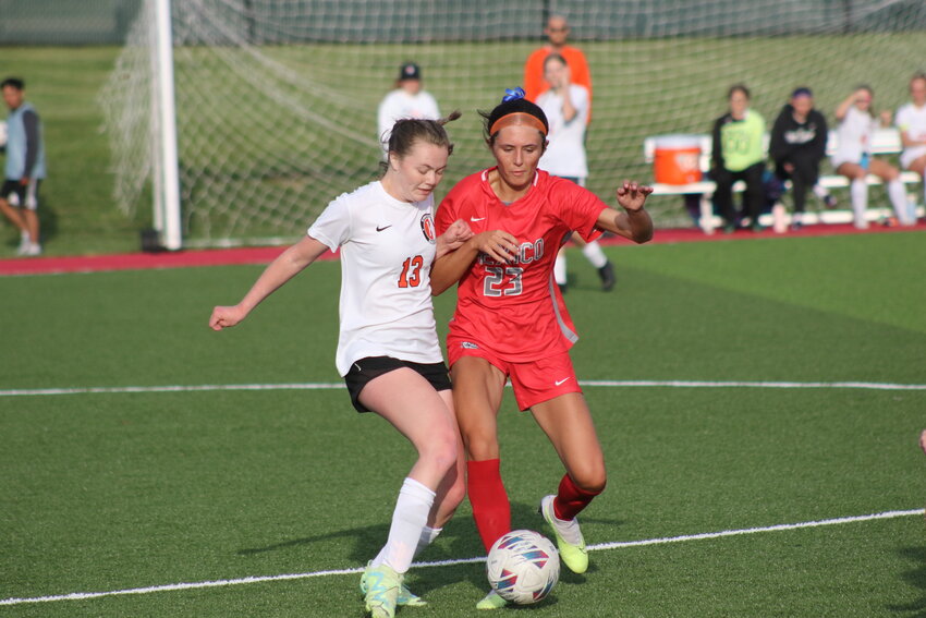 Mexico junior Emily Moppin fights for possession with Kirksville's Carrigan Maggart on Monday at Chris Hotop Field in Mexico. Mexico lost 3-1.