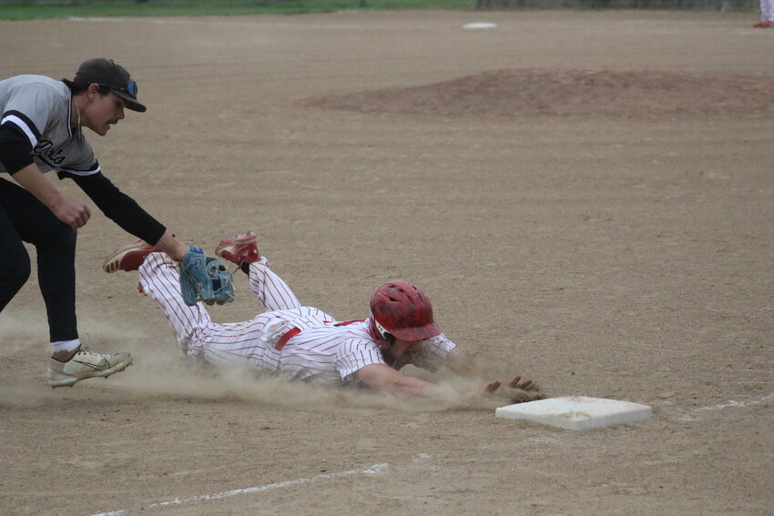 Community R-6 sophomore Lane Carter slides into third base before the tag is applied by Cairo on Thursday at home in Laddonia.