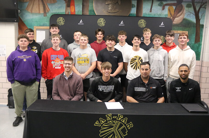 Van-Far senior Nikos Connaway gathers with his family, coaches and teammates on April 23 at Van-Far High School in Vandalia for his signing ceremony to play basketball for William Woods University in Fulton.