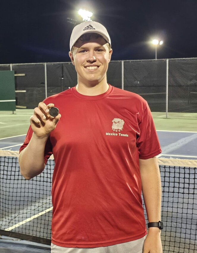 Mexico senior Brendan McKeown holds up his all-district medal and grins because he qualified for sectionals this Saturday at 10 a.m. in Mexico. McKeown finished second in singles on Friday in Mexico and Fulton.