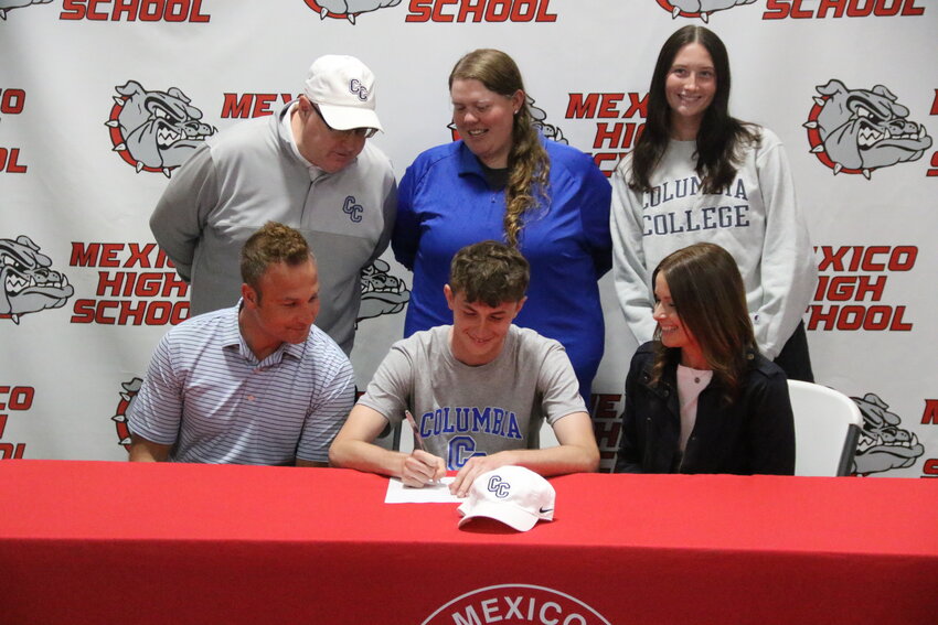 Mexico senior Aidan Knipfel signs his letter of intent to play golf for Columbia College while his family and Columbia College head coach Barry Doty watch on May 2 at the Mexico Sports Complex.