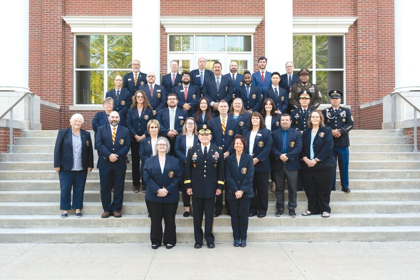 MMA faculty stand with President Brigadier General Richard V. Geraci, USA (Ret), on the steps of Stribling Hall.