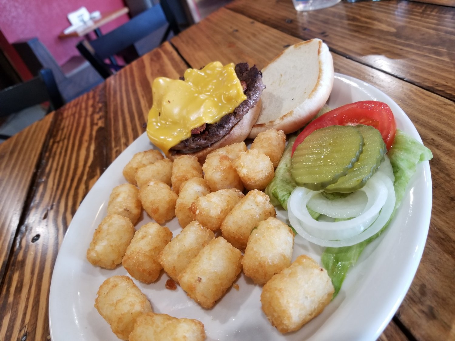 A simple burger and tater tots represents Bull Shooters’ approach to cooking: American diner fare in a friendly setting. [Dave Faries]