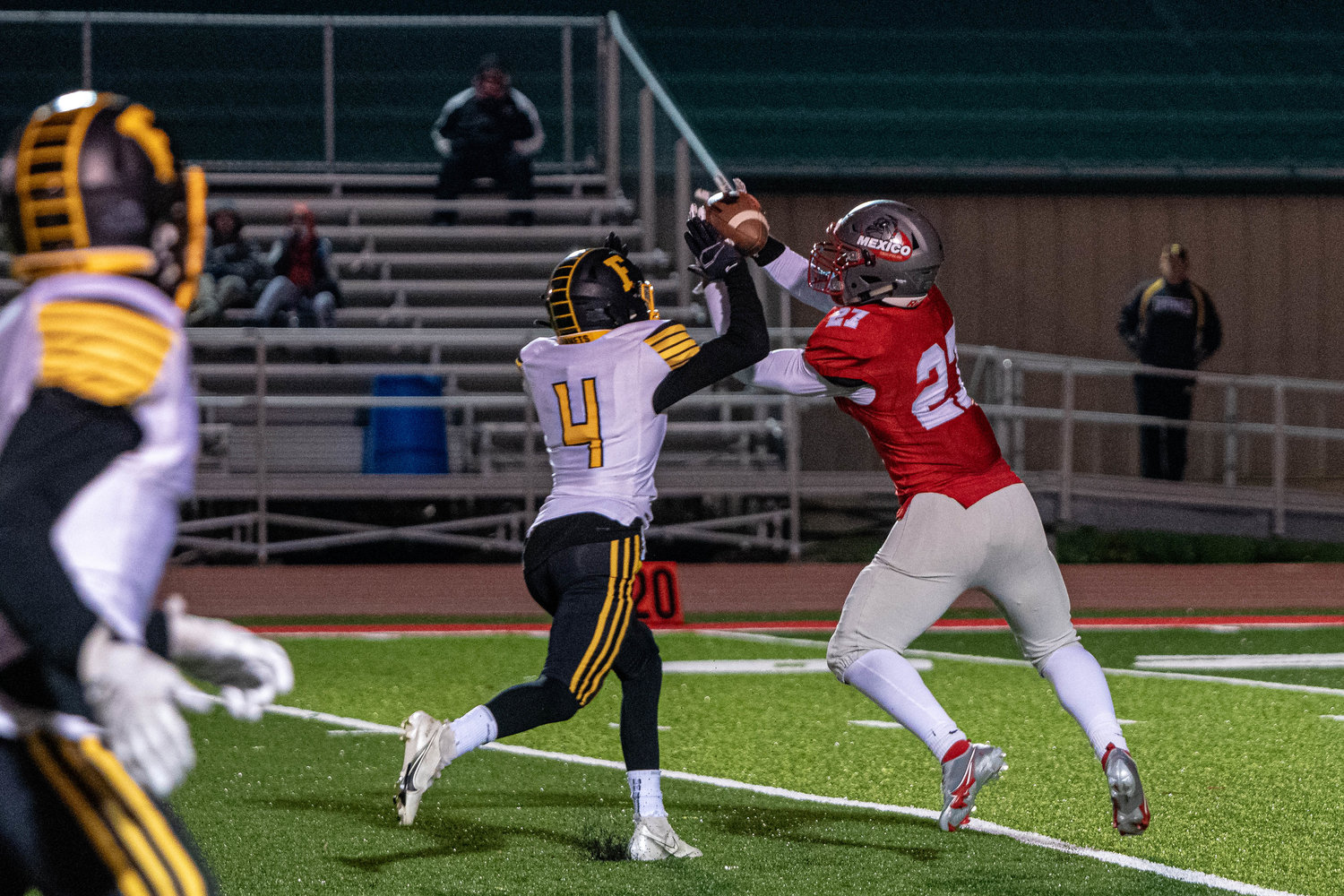 Mexico’s Shannon Dorsey reaches for a Ty Sims pass while trying to elude Fulton’s Will Privia during Friday night’s first round of the district bracket. Dorsey would take the ball to the house for a Bulldogs touchdown. (Eric Mattson)