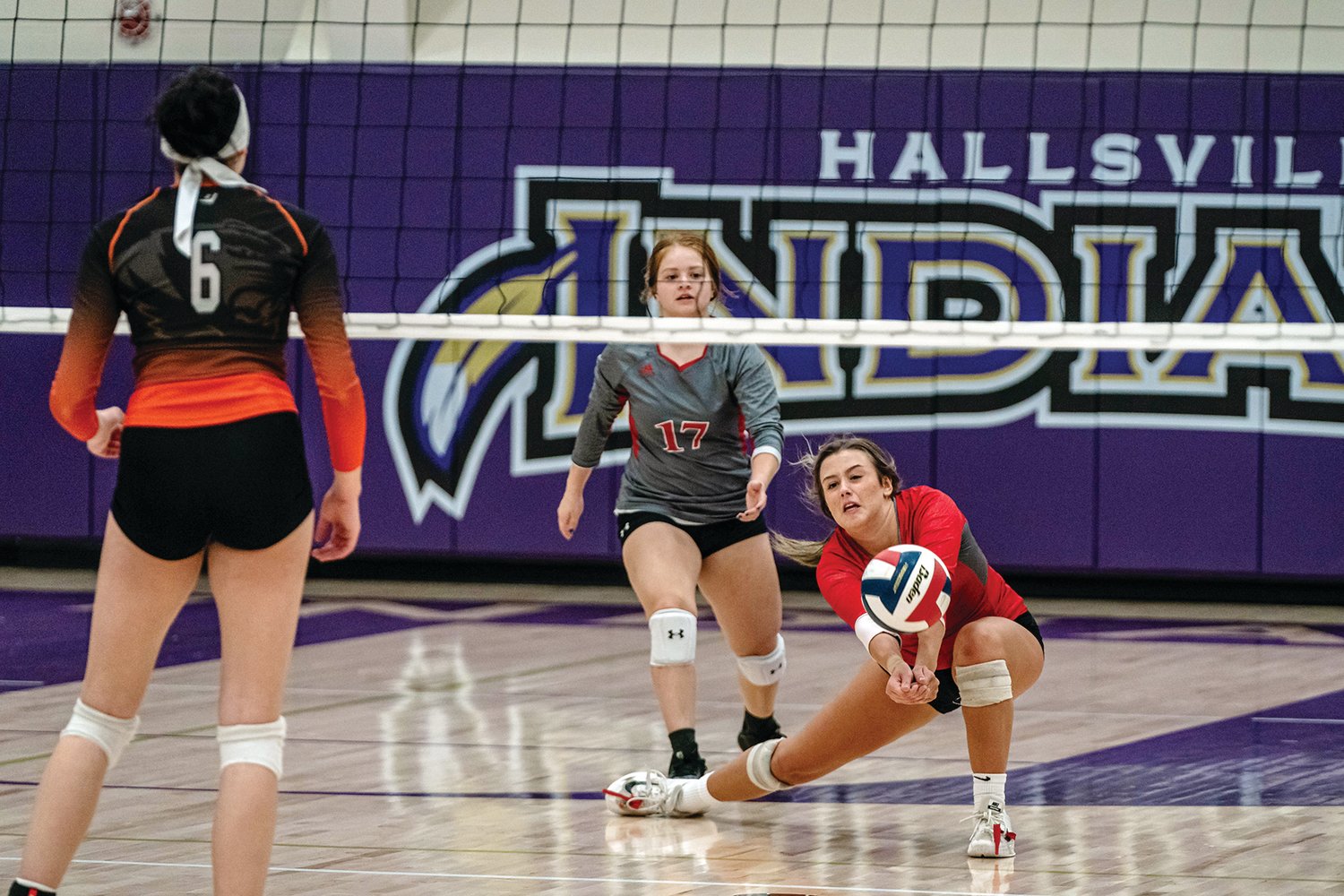 Addison McCoy hits the floor to dig out a Kirksville shot as Nayeli Ruiz hurries in for support during Tuesday night’s district final. The Bulldogs fought hard, but fell 3-1. (Eric Mattson)