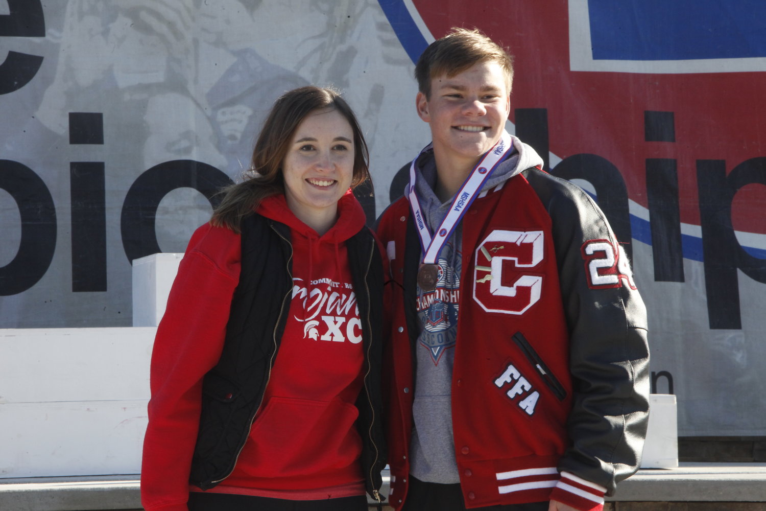 Community R-6 sophomore Dylan Hoyt poses with coach Josie Hess during the awards ceremony of the Class 1 state cross country meet on Nov. 6 in Columbia. Hoyt finished 17th with a 17:36. THEO TATE PHOTO