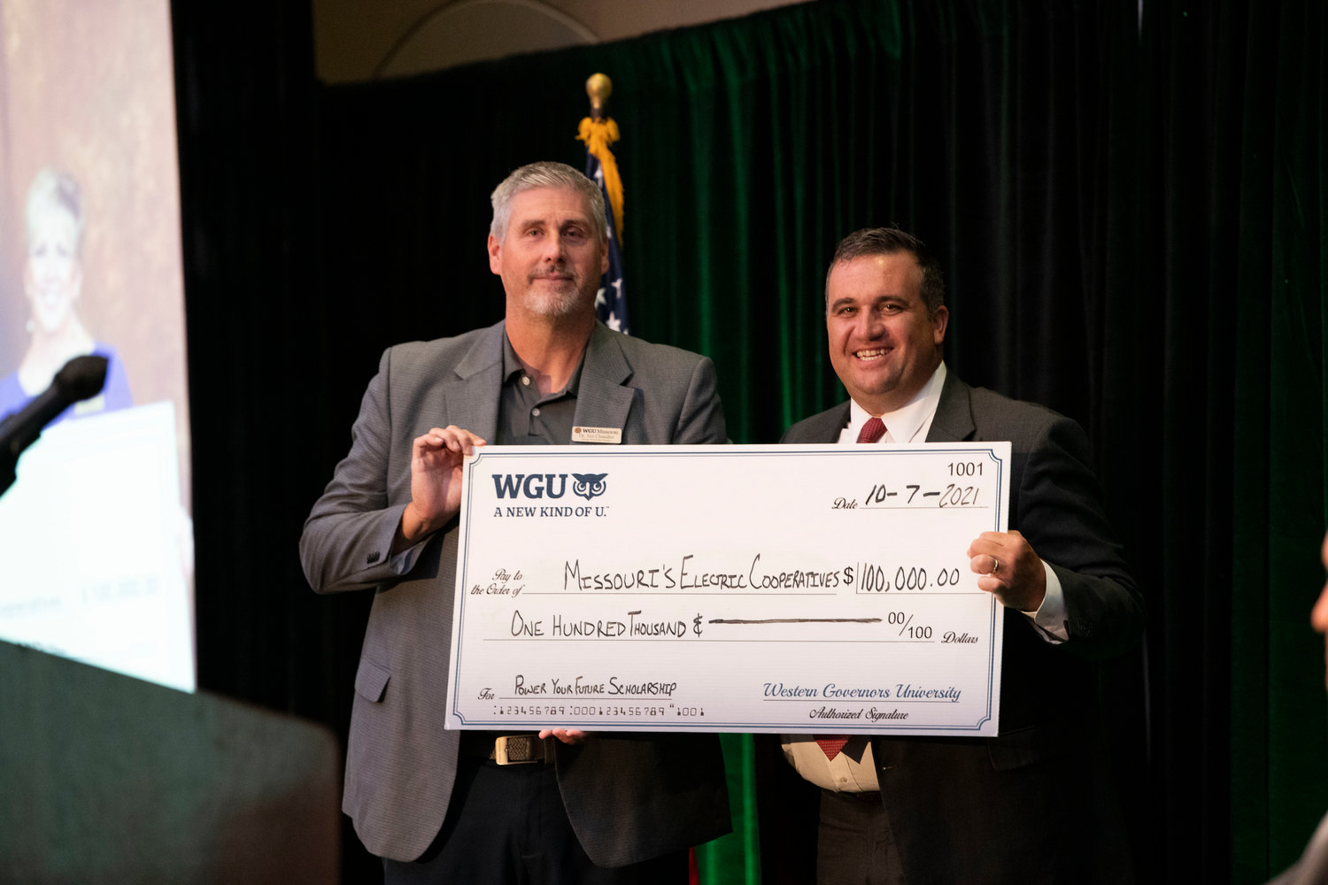 Jim Chandler, left, strategic partnerships manager with WGU Missouri, presents AMEC CEO Caleb Jones, right, with a check for $1 million to fund “Power Your Future” Scholarships for residents throughout the state. The check presentation was made during AMEC’s annual meeting, held in late September. WGU Missouri is working with AMEC to award $100,000 in scholarships to co-op members and employees who are interested in furthering their education. [Submitted Photo]