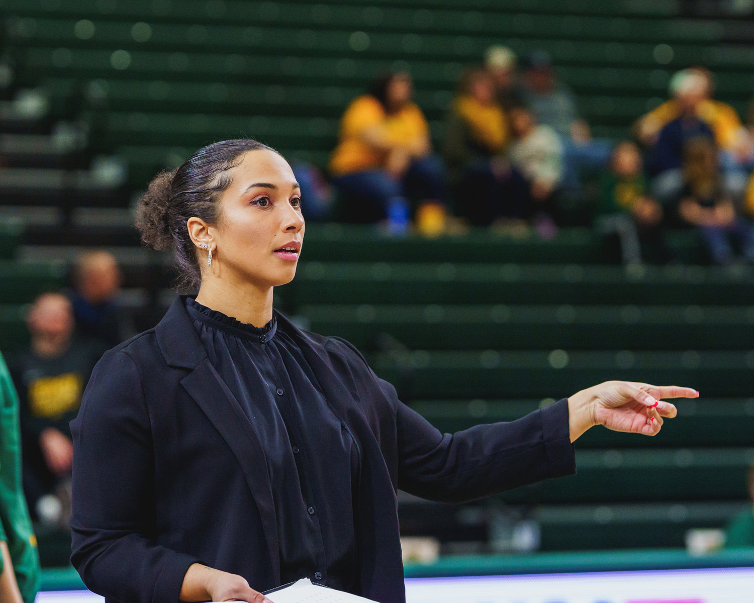 Mexico alum and newly hired Texas A&M Commerce assistant women's basketball coach Brooke Costley gives instructions to a player at her previous school, North Dakota State University.