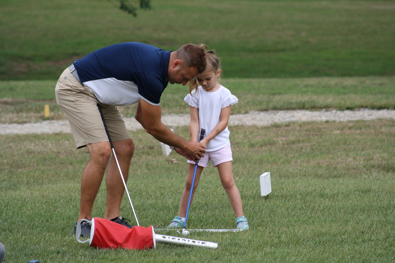 John Knipfel gives instructions during his junior golf camp Thursday at The Oaks golf course in Mexico.