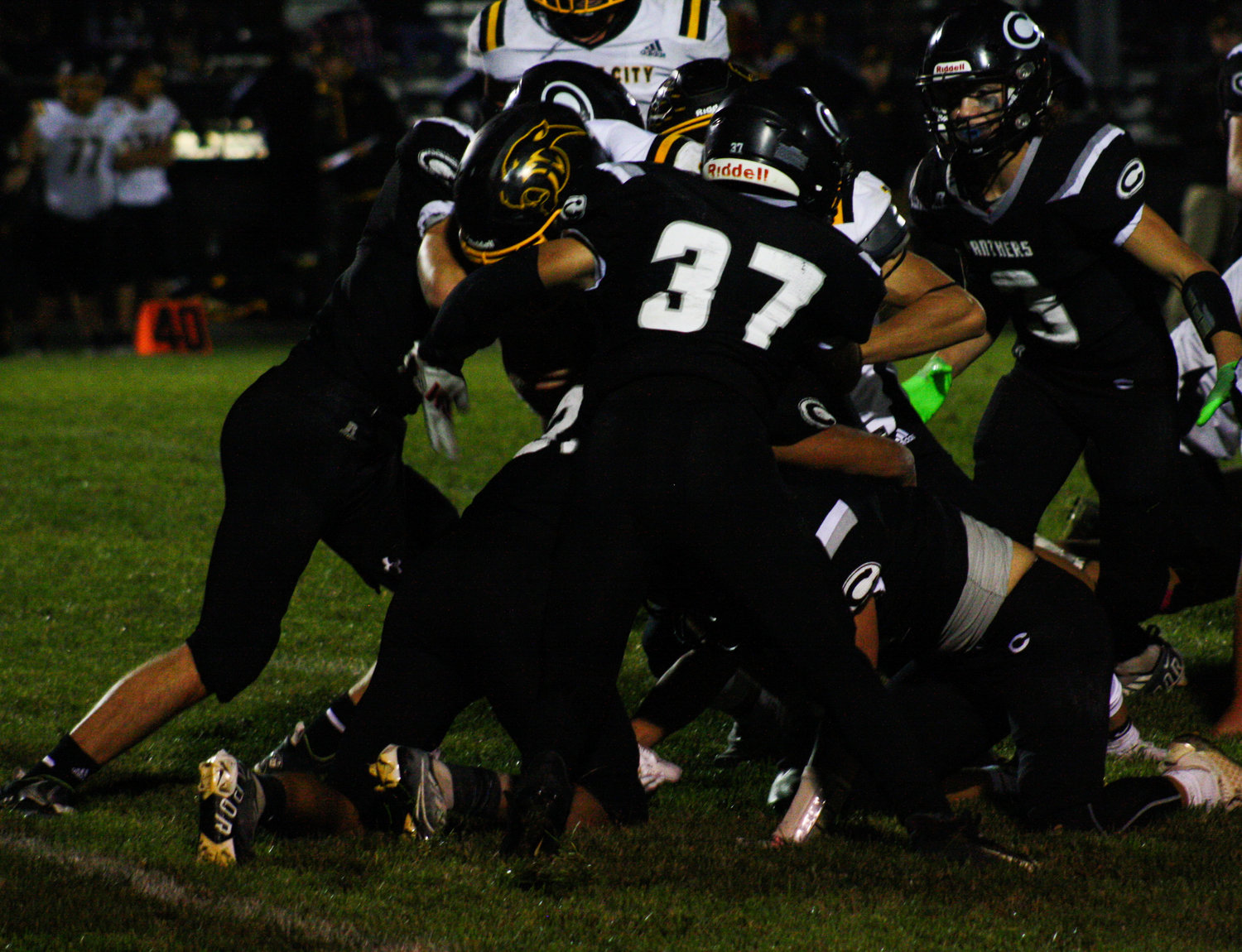Centralia junior linebacker Jesse Caballero (37) leads the swarm of Panthers on Friday in tackling Monroe City running back Ceaton Pennewell. Pennewell scored four touchdowns in Centralia's 28-7 loss at Miller Field in Centralia.