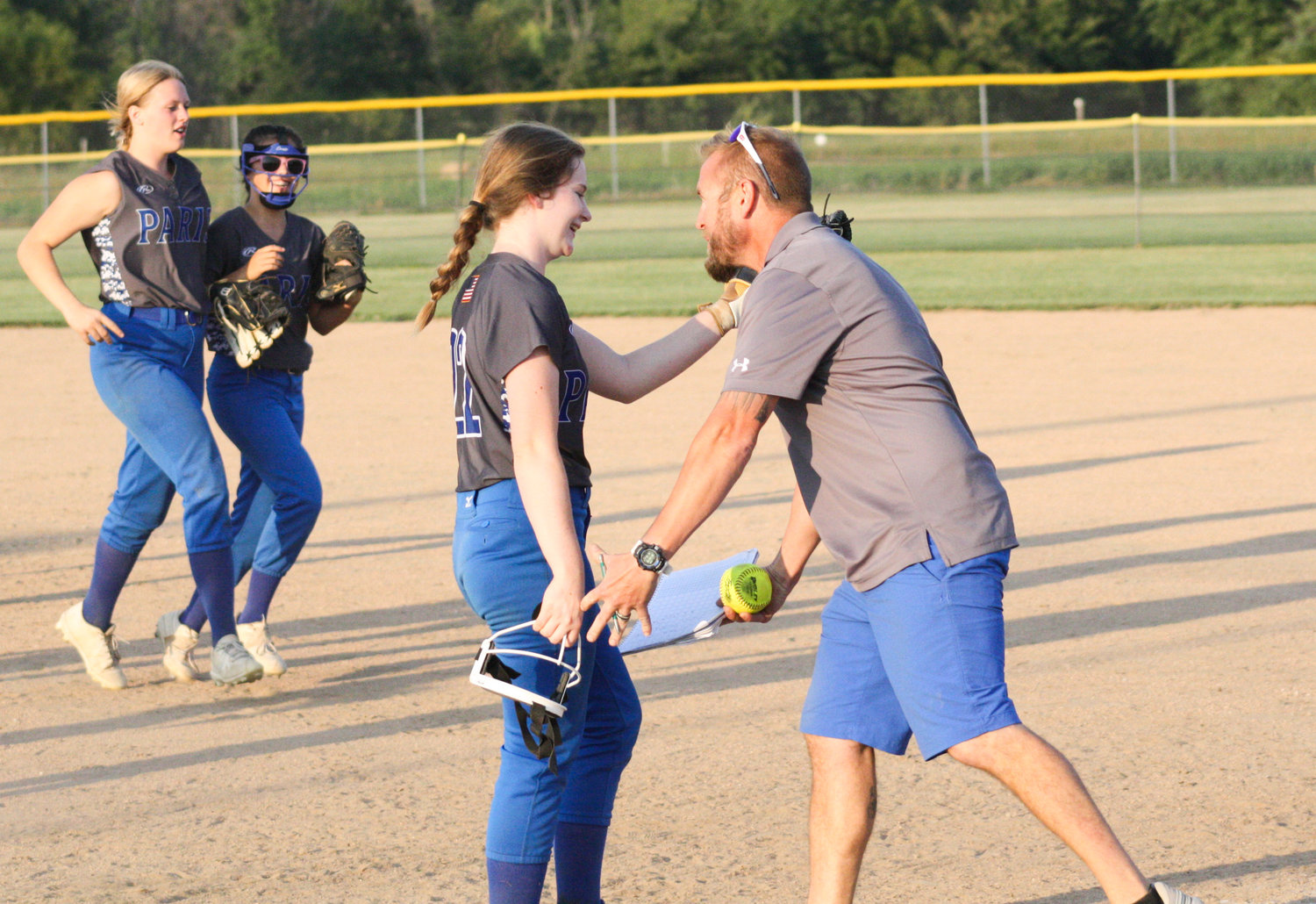 Paris sophomore pitcher Kennedy Ashenfelter is congratulated by head coach Collin Huffman after finishing a complete game shutout Sept. 14 at Community R-6. Ashenfelter no-hit Madison in what was the first of two district victories for the Lady Coyotes.
