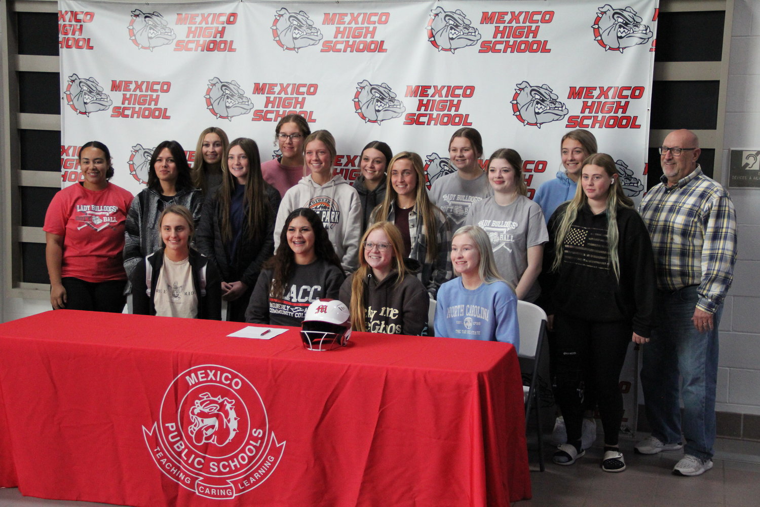 Mexico senior pitcher Eboni Mayfield is surrounded by her teammates and coaches Friday at the Mexico Sports Complex during her letter of intent signing ceremony to play softball at Moberly Area Community College. Mayfield earned all-district honors after taking a season off.