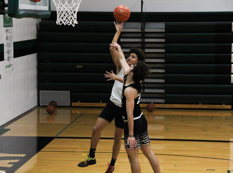 North Callaway senior Matthew Weber shoots over junior Sam Pezold during a practice. The duo led the Thunderbirds in scoring last season and are expected to have big roles this season.