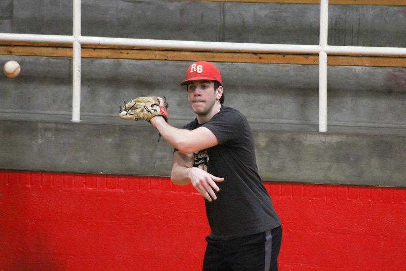 Community R-6 senior Gavin Allen makes a throw Monday during practice. Allen and junior Mason Carroll were all-conference players for the Trojans a year ago.