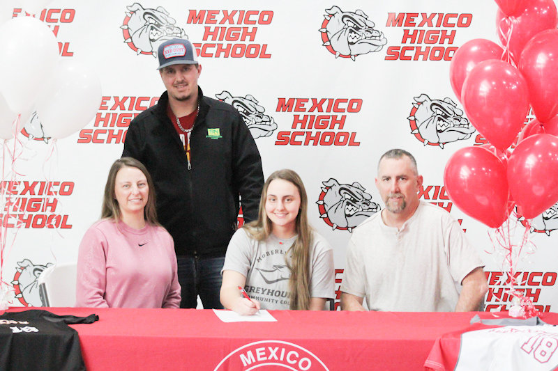 Mexico senior Kierstan Epperson is surrounded by her family on Friday during a ceremony to reveal her signing to Moberly Area Community College softball.
